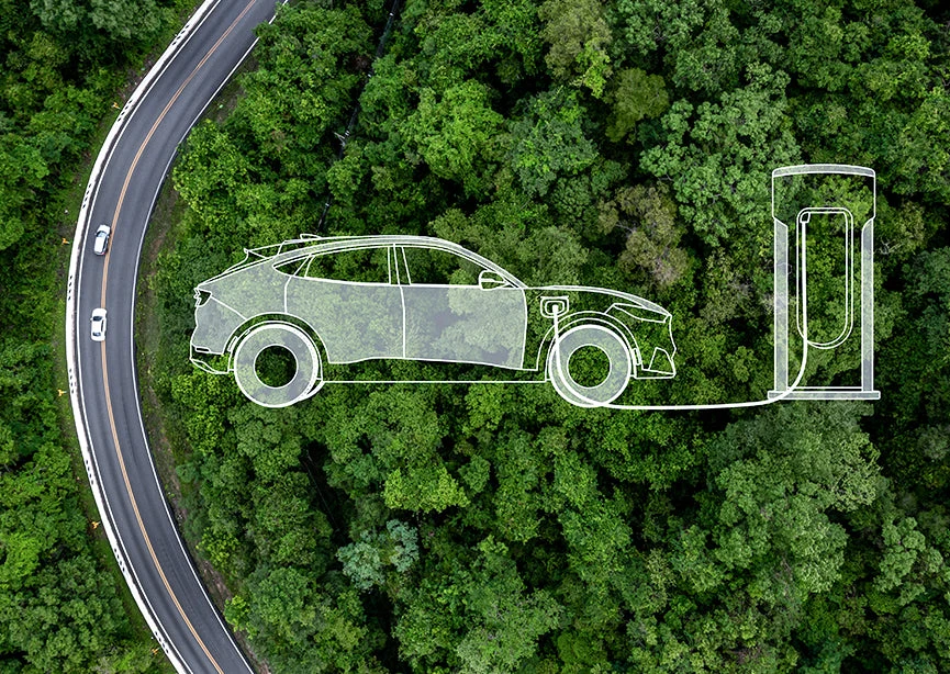 An aerial view of a forest road with electric mobility symbols